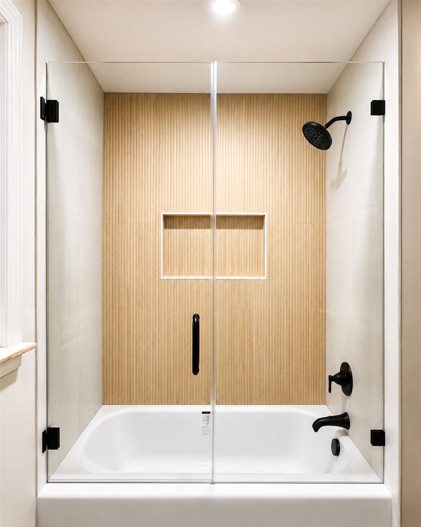 Frameless glass panel and door enclosure over a bathtub