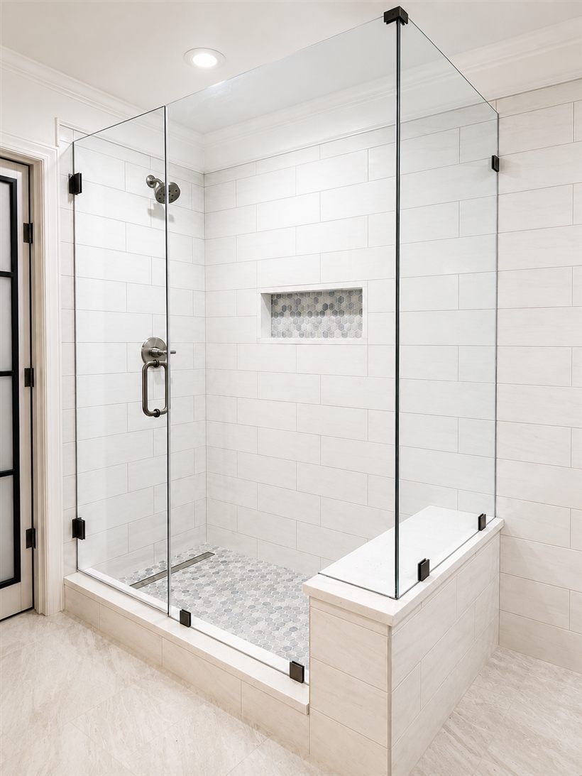 Frameless corner shower enclosure with a built-in bench