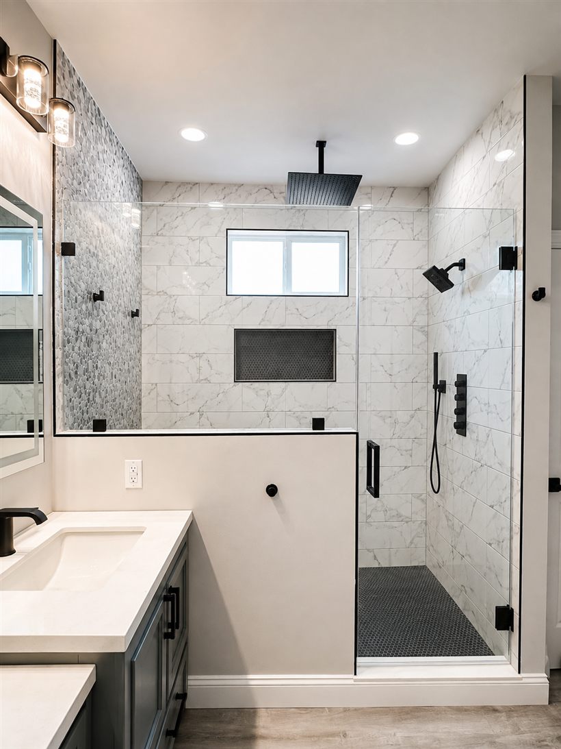 Frameless shower with panel and door over a half wall