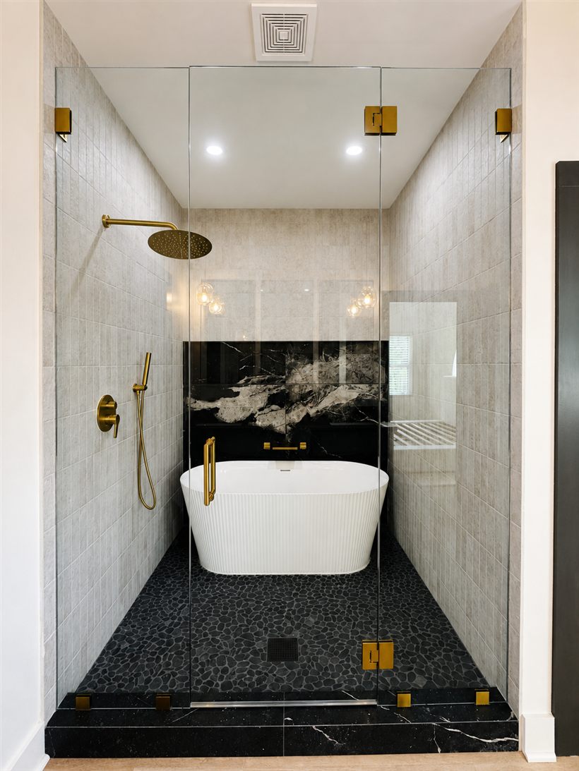 Frameless shower with two fixed glass panels and a hinged door